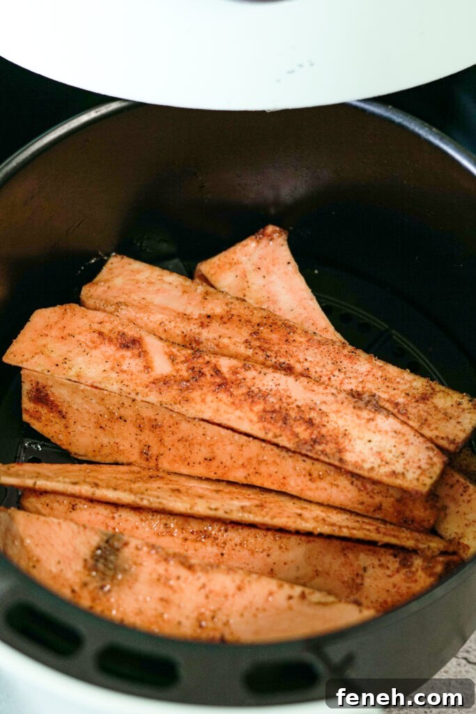 seasoned sweet potatoes in air fryer basket