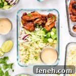 air fryer honey sriracha chicken bowls with dressing and cilantro on top.