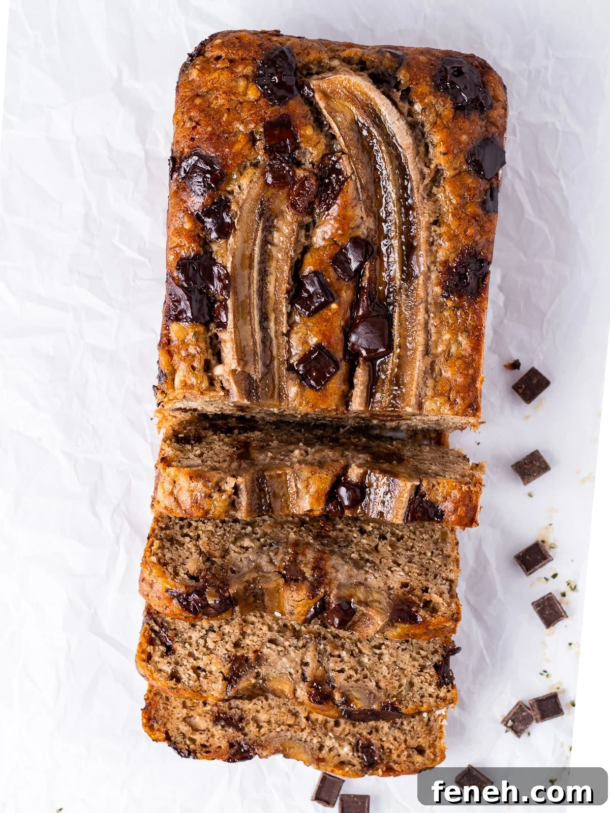 loaf of banana bread with chocolate chunks and a banana on top