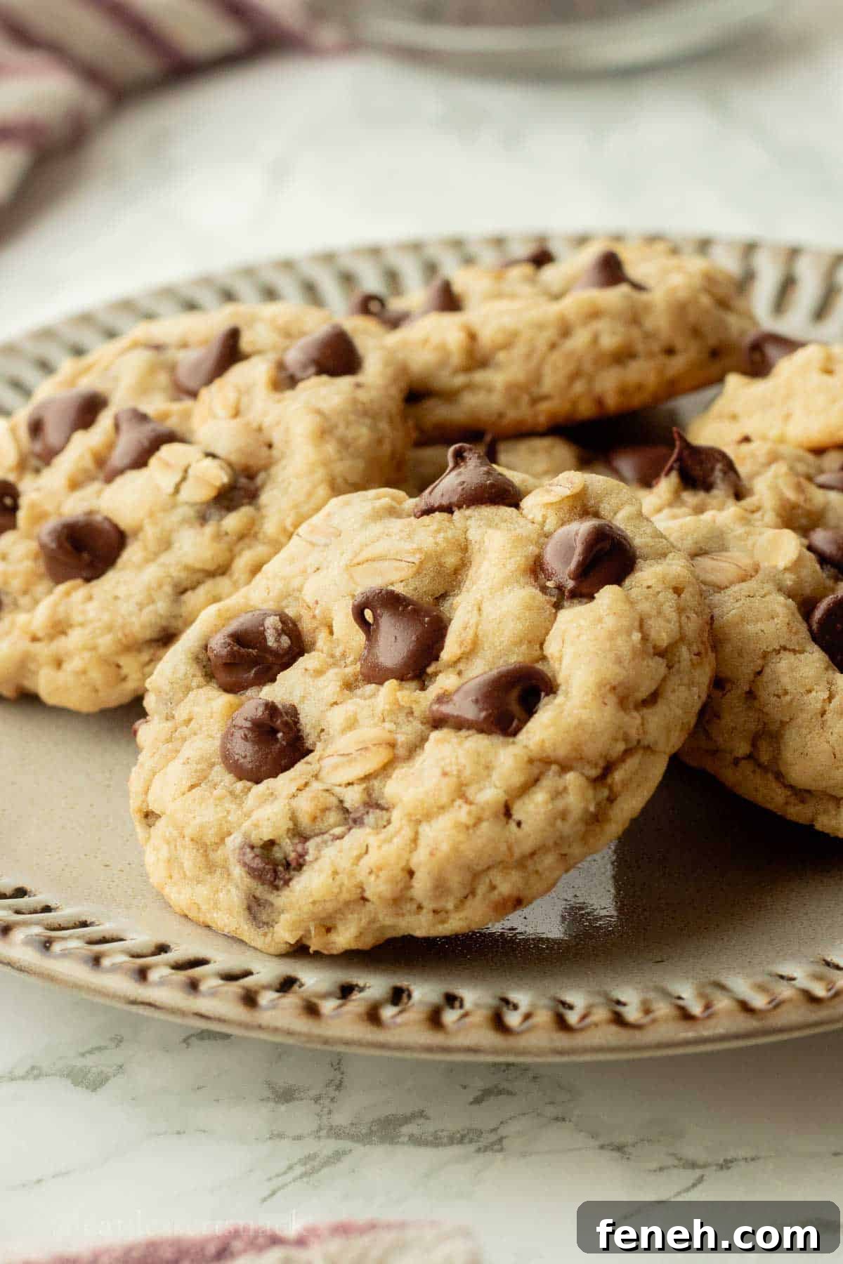Baked sourdough oatmeal cookies on ceramic plate.