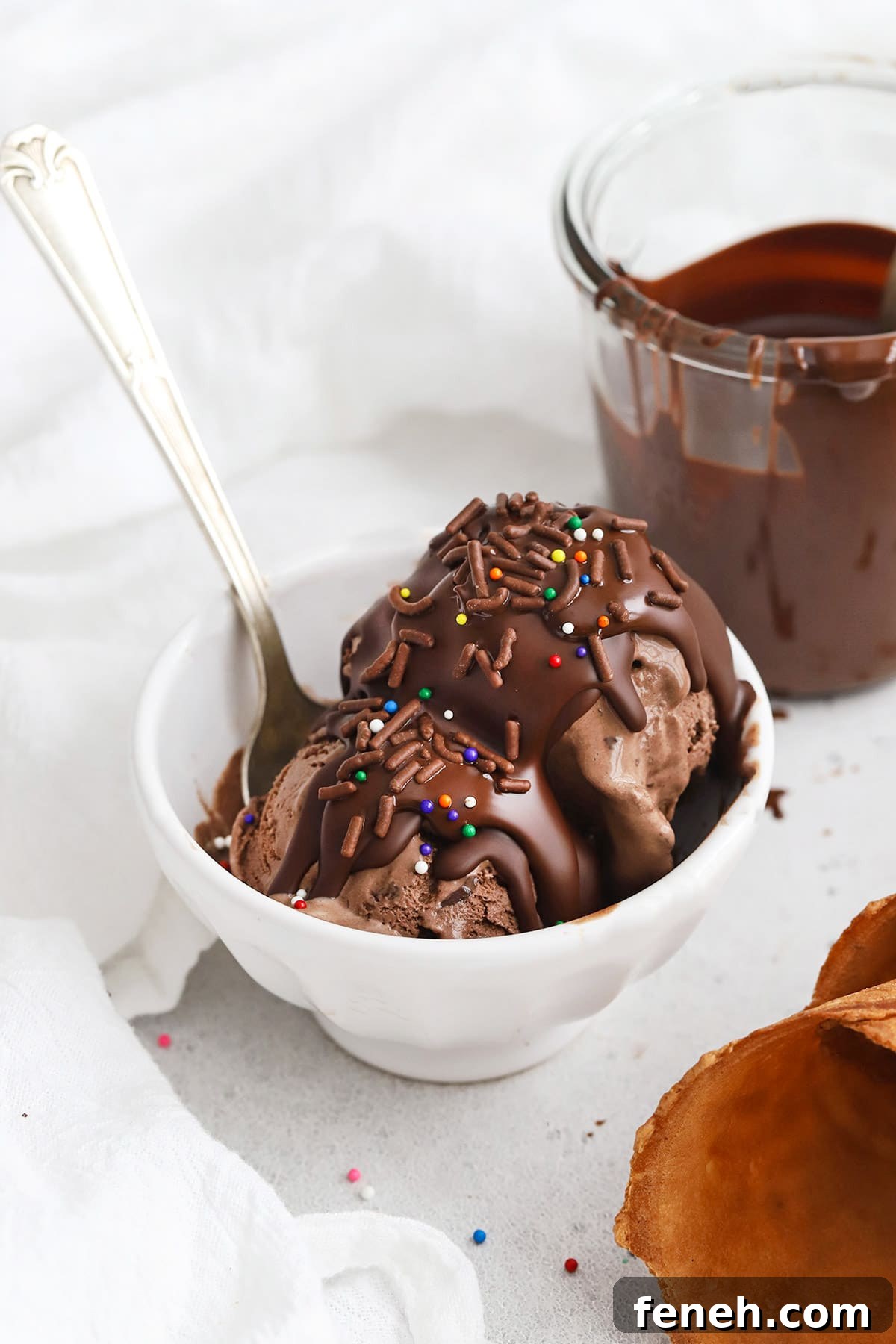Homemade 2 ingredient magic chocolate shell on chocolate ice cream, topped with sprinkles