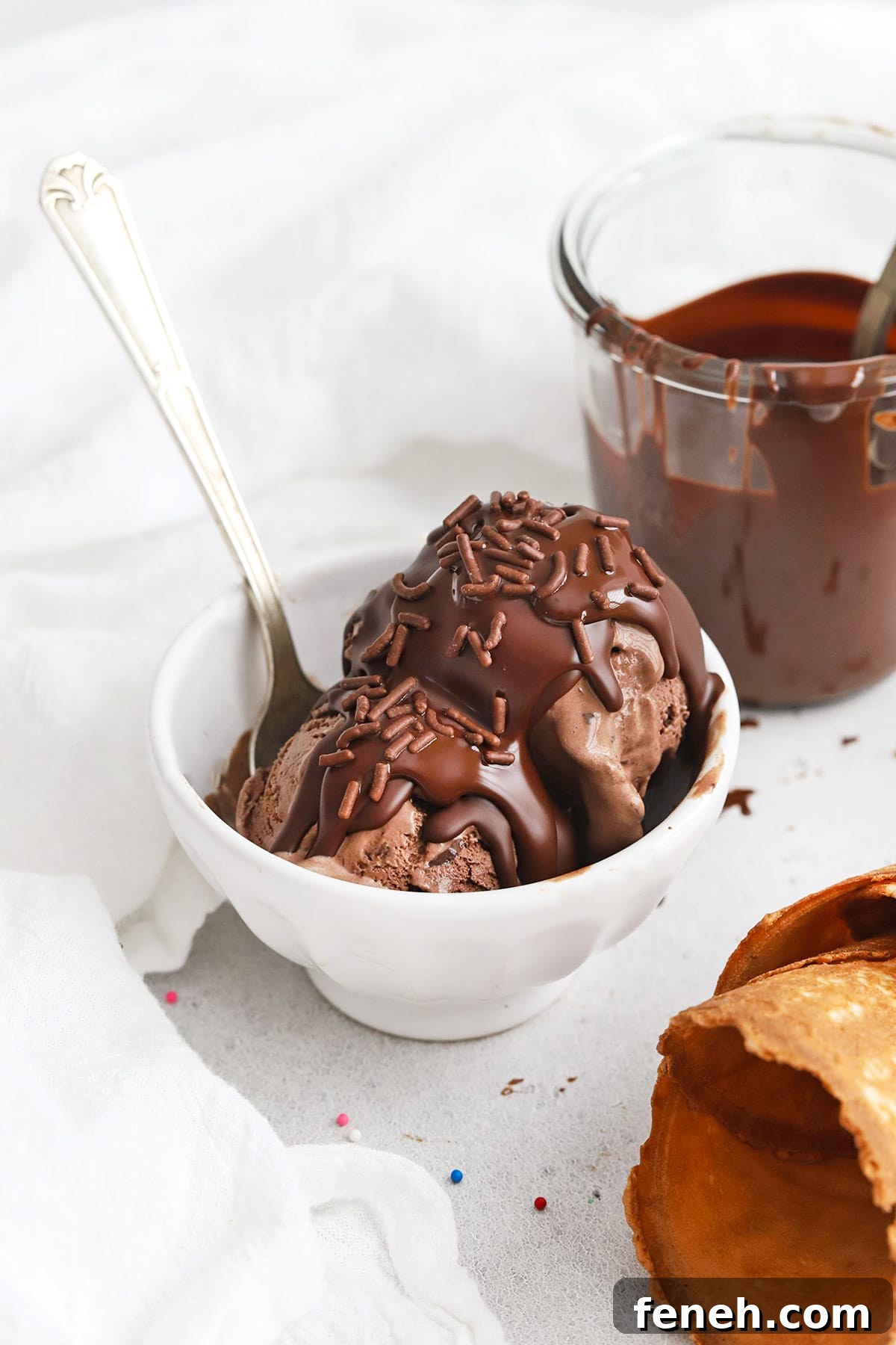 Homemade 2 ingredient magic chocolate shell on chocolate ice cream, topped with sprinkles