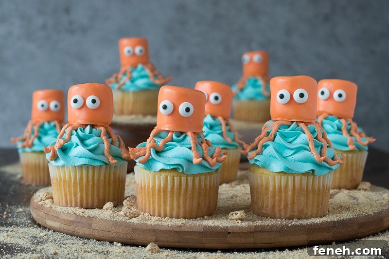 Eight delicious Octopus Cupcakes arranged on on a wooden board for the perfect under the sea party!